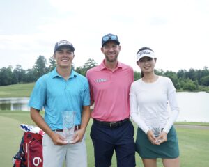 A young woman and man surround a pro golfer with trophies in hand